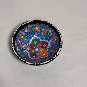 vintage hand-painted Turkish Bowl. Vibrant blue background colorful dot pattern.